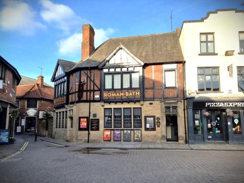 an old building on the corner of a street at The Roman Bath in York