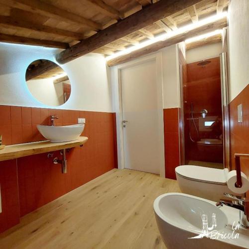 a bathroom with two sinks and a mirror at La Bricola - Buora in Chioggia