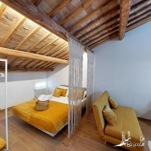 a bedroom with a bed and a couch in a room at La Bricola - Buora in Chioggia