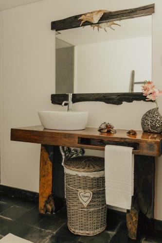 a bathroom with a sink on a wooden table at Refúgio da Cancela - Arouca Stay in Arouca