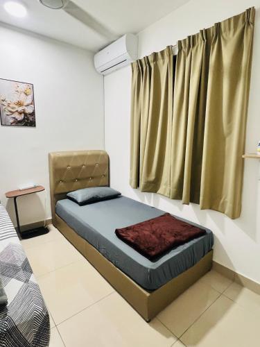 a bedroom with a bed and a window at JC COZYsTAY RAWANG in Rawang