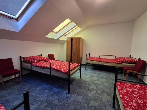 a room with three bunk beds and a skylight at Jugata in Rudna Wielka