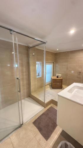 a bathroom with a shower and a sink at House close to the beach of Punta Prima in Punta Prima