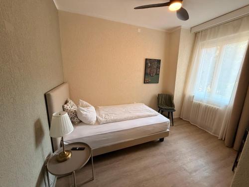a small bedroom with a bed and a window at AL BOCCALINO Bed & Breakfast Melide Lugano Ticino in Melide