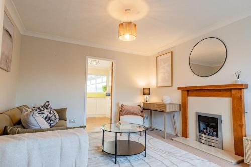 a living room with a couch and a fireplace at Drovers Way, Worcester in Fernhill Heath