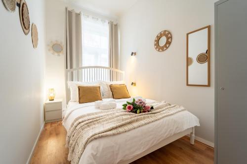 a bedroom with a white bed with flowers on it at Celine Prague Luxury Hostel in Prague