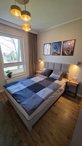 a large bed in a bedroom with a large window at Wyspa9 - Gdańsk Wyspa Sobieszewska in Gdańsk