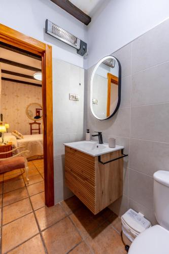 a bathroom with a sink and a mirror at El Cerrillo in Navaconcejo