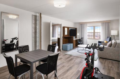 a living room with a table and a scooter in a room at EVEN Hotel Chicago - Tinley Park - Convention Center by IHG in Tinley Park