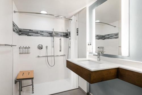 a bathroom with a sink and a shower at EVEN Hotel Chicago - Tinley Park - Convention Center by IHG in Tinley Park