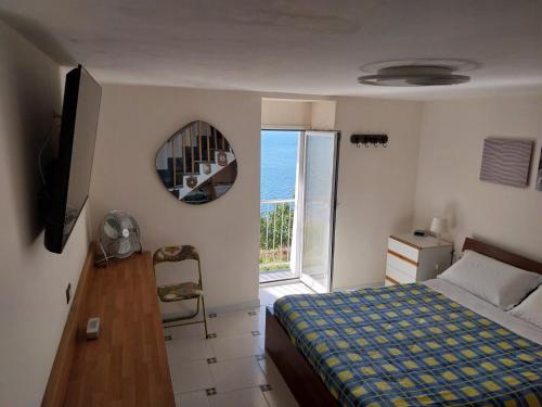 a bedroom with a bed and a view of the ocean at Turchese in Amalfi