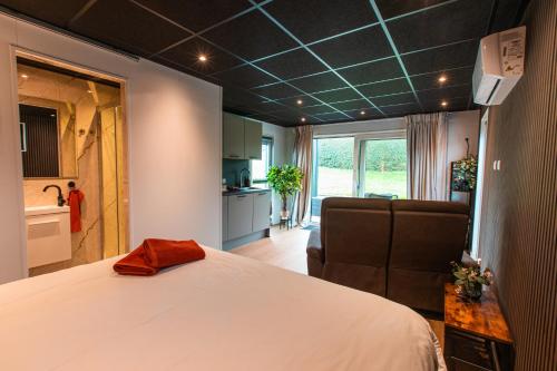 a bedroom with a large bed and a kitchen at Tiny boat house #2 in Garnwerd