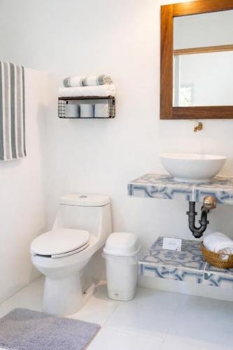 a bathroom with a toilet and a sink at Paradise Renewed Beach House for Deep Relaxation in El Cuyo