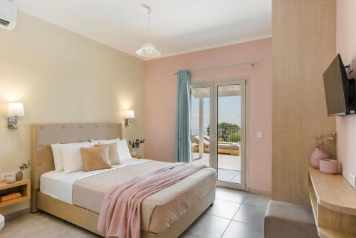 a bedroom with a bed and a balcony at Saint Nicholas Villas 5 in Skala