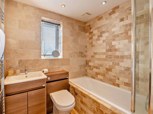 a bathroom with a tub and a toilet and a sink at 2 Bed in Middlesbrough oc-75226 in Great Ayton