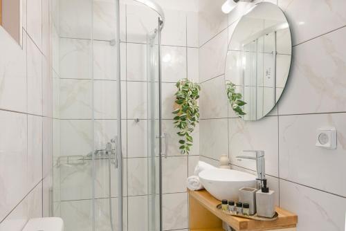 a white bathroom with a sink and a mirror at Saint Nicholas Villas 5 in Skala