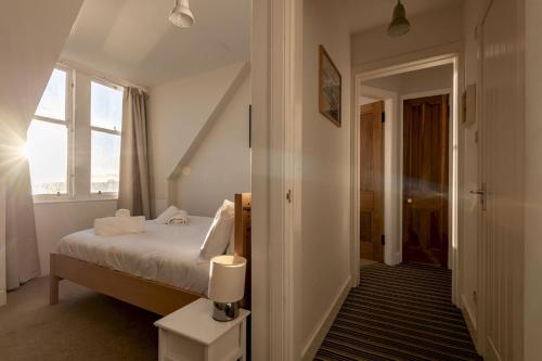 a bedroom with a bed and a window at Harbour View - Anstruther in Anstruther