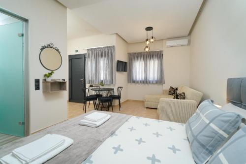 a living room with a bed and a dining room at Giorgio Suites in Asprovalta