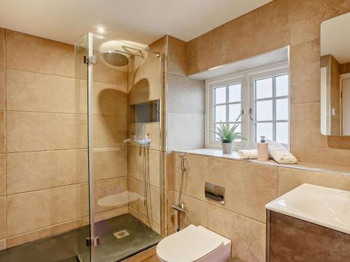 a bathroom with a shower and a toilet and a sink at 5 Bed in Leeds oc-91355 in Sherburn in Elmet