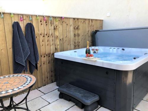 a bath tub with a bottle of champagne in it at 2 Bed in Stokesley oc-g0072 in Carlton