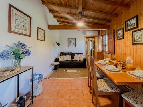 a kitchen and living room with a table and a couch at Casa Largo do Porto - Country House with Swimming Pool in Viana do Castelo