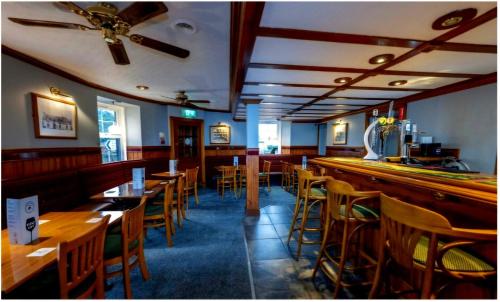 a bar with wooden tables and chairs in a restaurant at St Michaels Hotel in St. Michaels
