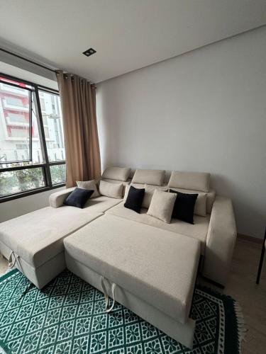 a bedroom with two beds and a large window at Ijou gdena in Sidi Daoud