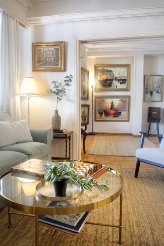 a living room with a couch and a coffee table at Art Gallery Hotel Athens in Athens