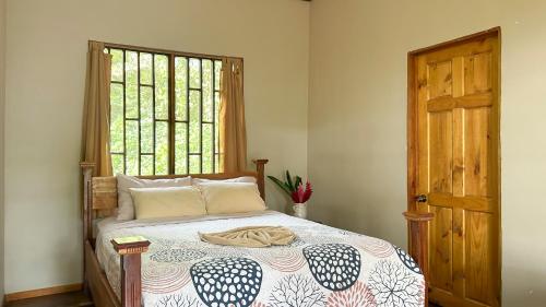a bedroom with a bed and a window at Casa Grande at Pacuare Reserve in Matina