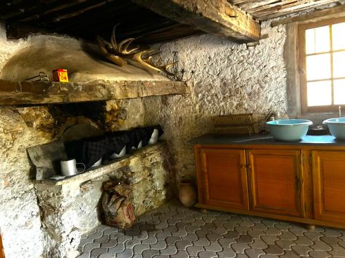 a kitchen with a stone wall with a stone oven at Maison Nomade Provence - MaisonNomadeChic in Coursegoules