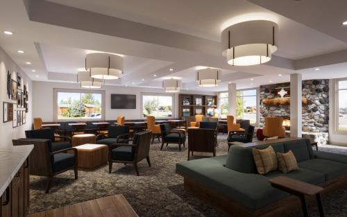 a lobby with a waiting room with couches and chairs at Gray Wolf Inn & Suites in West Yellowstone