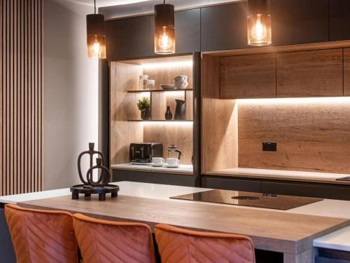 a kitchen with a counter with chairs and a table at 4 Bed in Morpeth oc-93775 in Thropton