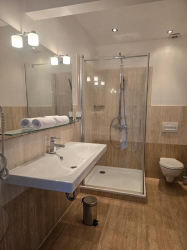 a bathroom with a sink and a shower at Apartment in a Chateau with Park in Trébry