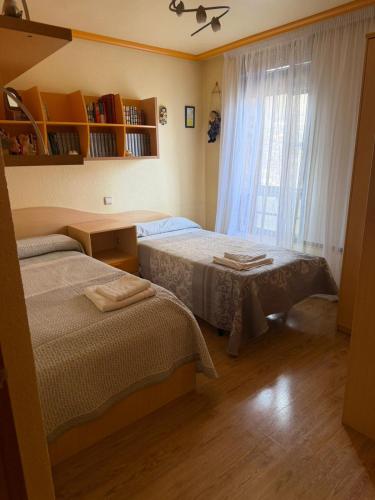 a bedroom with two beds and a window at KyN in Cornago