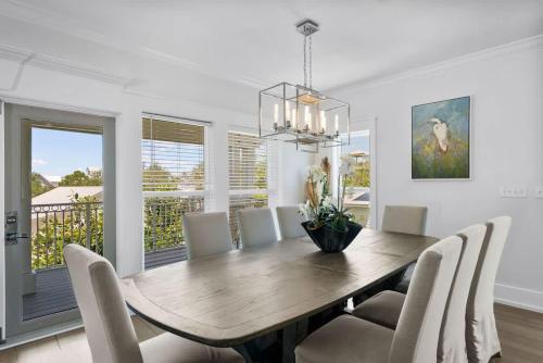 a dining room with a wooden table and chairs at 80 Blue Sky in Santa Rosa Beach