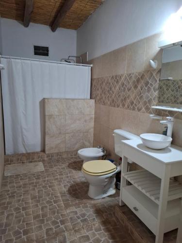 a bathroom with a toilet and a sink at San Antonio Casa Quinta in Banda Florida