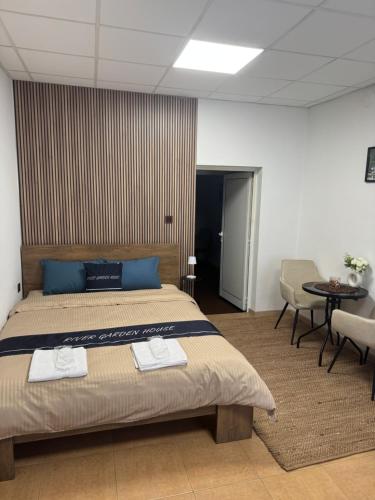 a bedroom with a bed with two towels on it at River Garden House in Vidin