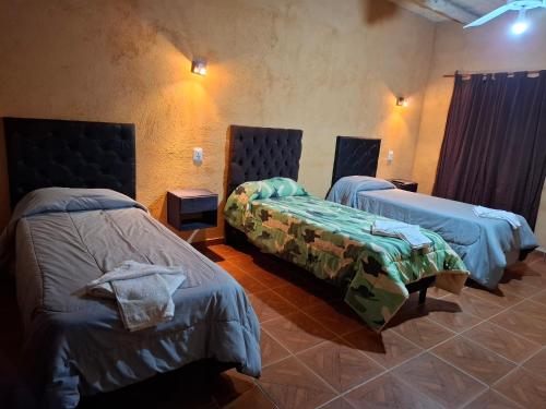 a room with two beds in a room at San Antonio Casa Quinta in Banda Florida