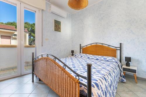 a bedroom with a bed and a large window at Gelso Selvatico by BarbarHouse in Specchiolla