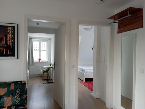 a white room with a bed and a window at Peaceful Apartment-3 Zi, Loggia & Garden in Blankenese in Hamburg