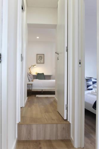 a hallway leading to a bedroom with two beds at Valbom Hideaway Light, Style and Peace in Valbom