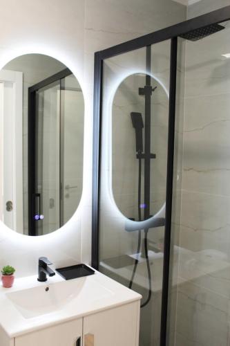 a bathroom with a shower and a sink and a mirror at Valbom Hideaway Light, Style and Peace in Valbom