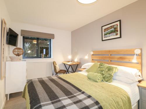 a bedroom with a bed and a table and a window at The BullpenManor Farm in Salisbury