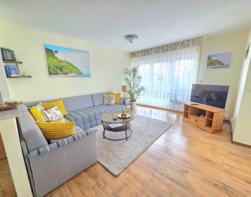 a living room with a couch and a table at Komfortferienwohnung Kreideblick in Sassnitz