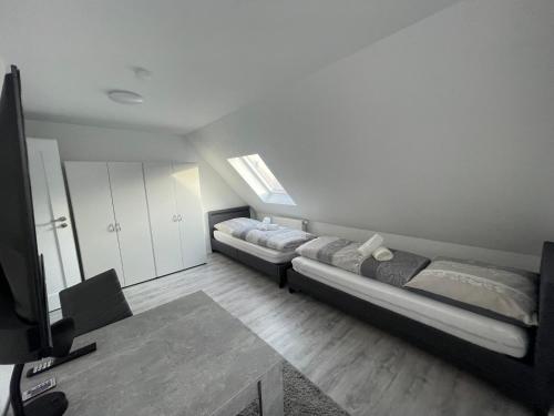 a living room with two beds and a tv at 5-Täler Stern in Geislingen an der Steige