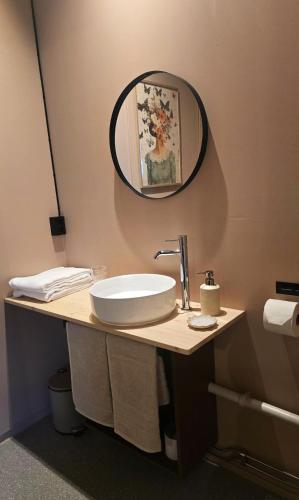 a bathroom with a sink and a mirror on the wall at Kuben Utleie in Narvik