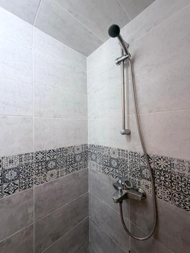 a shower in a bathroom with a shower head at Hakuna Matata Guest House in Tamraght Ouzdar