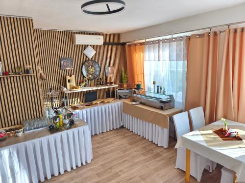 a living room with two tables and a dining room at Wellness Hotel Staré Město in Uherské Hradiště