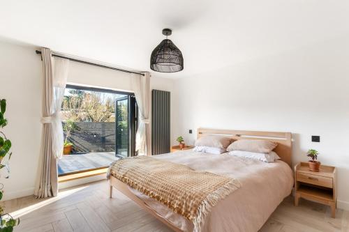 a bedroom with a large bed and a large window at Cosy Nook at Jam Jar Kitchen in Crantock