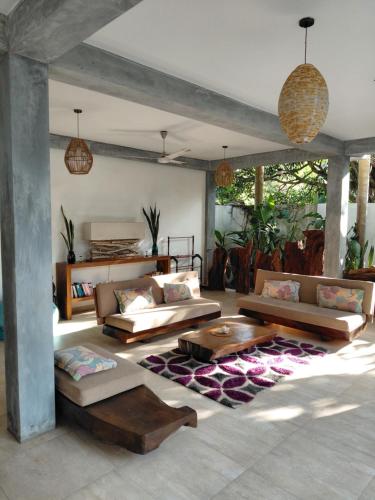 a living room with couches and a coffee table at Villa Mosaic in Tangalle